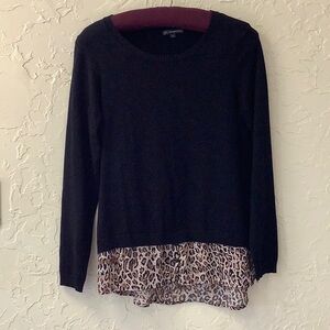 Top of light weight sweater knit with fashionable animal print faux underlay.